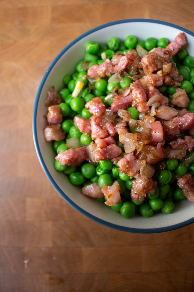 Peas with pancetta are the perfect easy side dish! The pancetta makes them seem elegant, but they're simple enough to toss together in ten minutes!