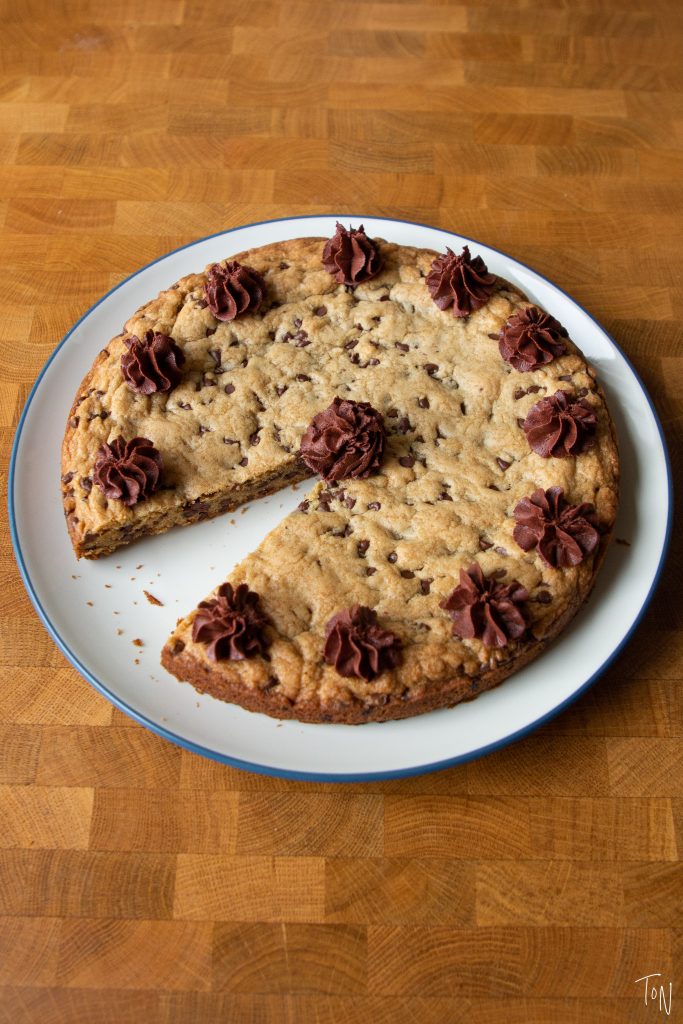 Making a classic chocolate chip cookie cake at home is crazy easy! Here's what you need to know to make your own.