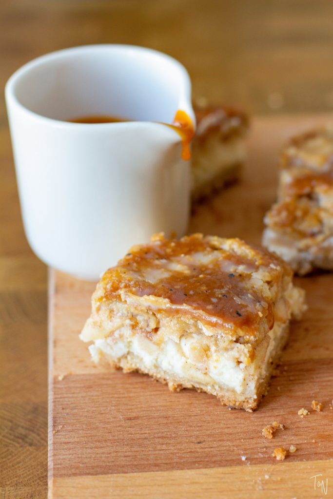 Caramel apple cheesecake bars give the best of the cravable comfort of apple pie and rich, gooey cheesecake!
