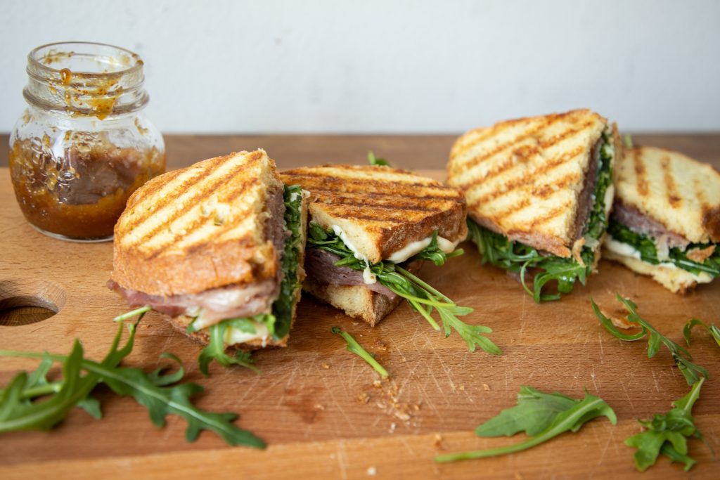 These prosciutto and mozzarella panini have a secret ingredient that ramp them up a notch to be the best sandwich you've ever tried!