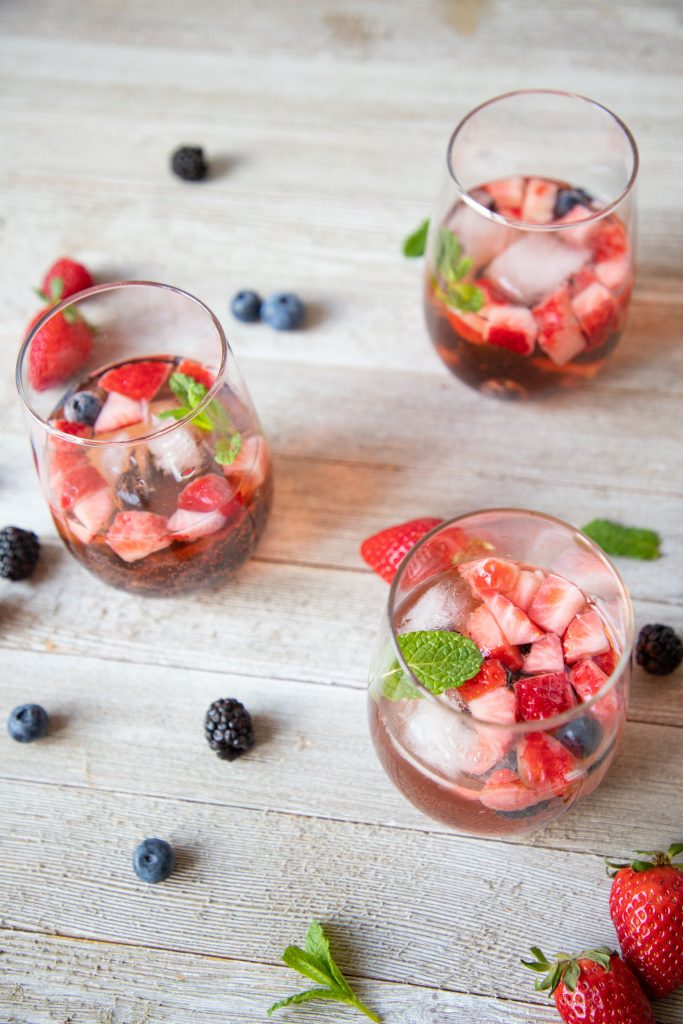 Berry rosé sangria is the perfect picnic sip! It's perfect to take on a day trip to the lake or the park, or just for a summer evening! | Teaspoon of Nose