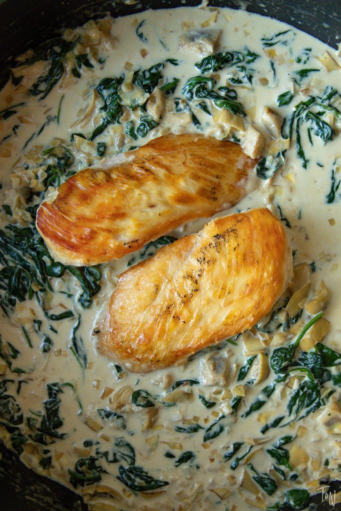 Creamy spinach artichoke chicken tastes like spinach dip in meal form! It comes together in 20 minutes and ...
